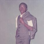Azuka as a schoolboy in a suit